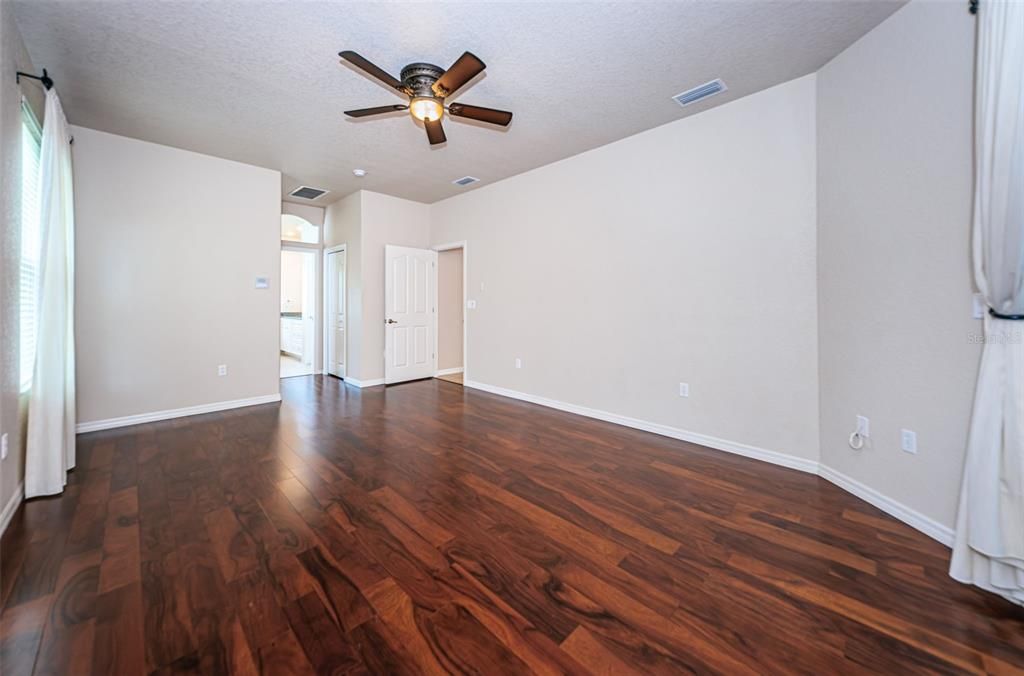 Spacious primary accommodates a full King suite of furniture.