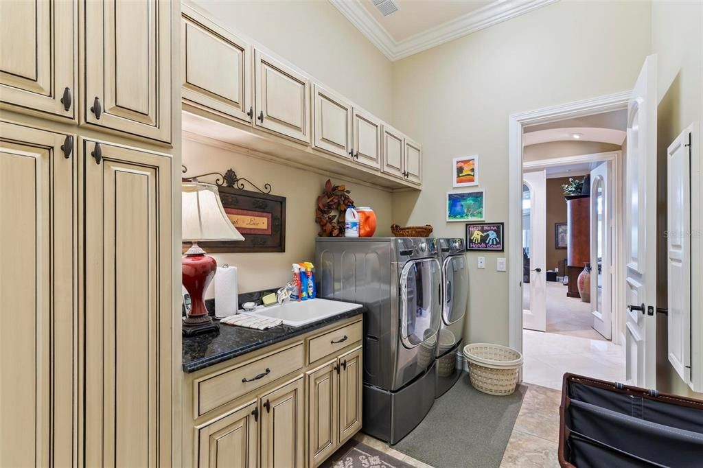 Large Laundry with Custom Cabinets, Utility Sink and Hidden Ironing Board
