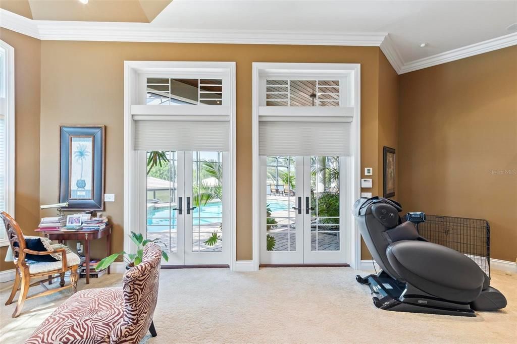 Double French Doors Allow Natural Light to Flow into Bedroom and lead to Outdoor Living Area