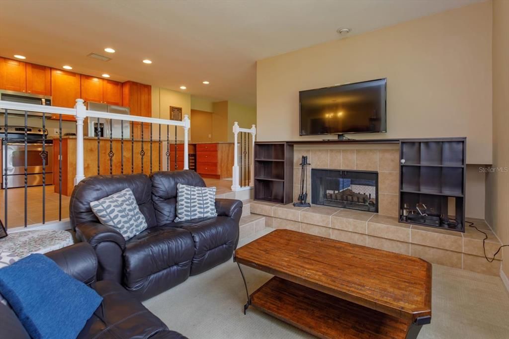 The living room is open to the kitchen with a 2-sided fireplace