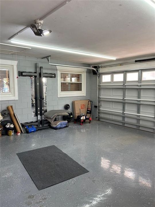 Garage w/ epoxy floors, entry to laundry room to left of photographer