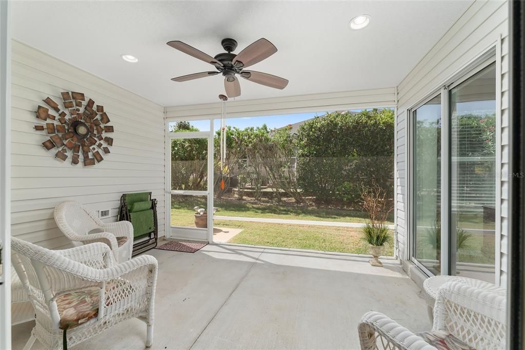 SCREENED LANAI WITH WICKER SEATING, CEILING FAN AND LIGHTING