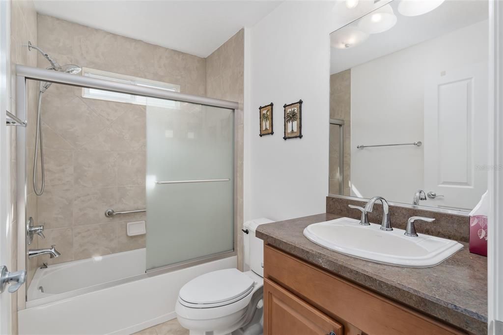 GUEST BATH HAS TUB/SHOWER COMBO, UPGRADED SINK AND FAUCETS, NICE LIGHTING AND WINDOW FOR NATURAL LIGHT.