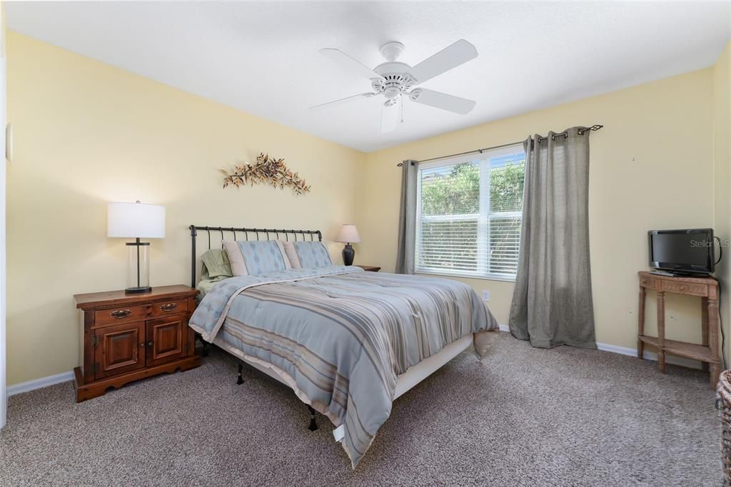 GUEST ROOM AT REAR OF HOME INCLUDES BED, NIGHT STANDS, ACCENT FURNISHINGS AND ACCESSORIES