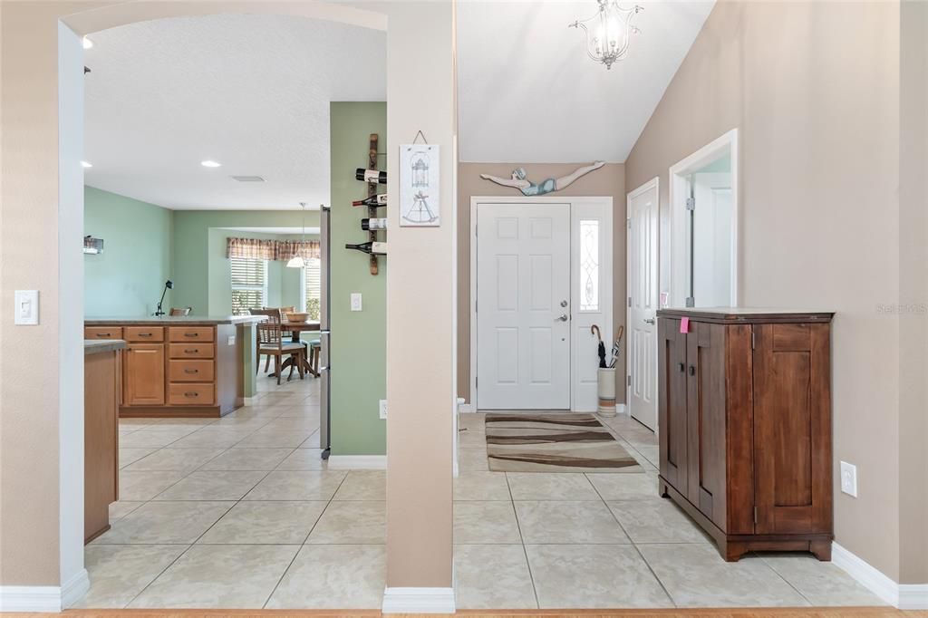 ENTRY HALL WITH CLOSET, ACCESS TO LAUNDRY ROOM AND KITCHEN, ALL WITH TILED FLOORS
