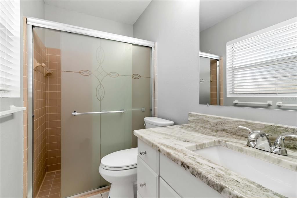 New vanity, sink and granite countertop. Comfort height new toilet. New glass bi-pass shower doors.