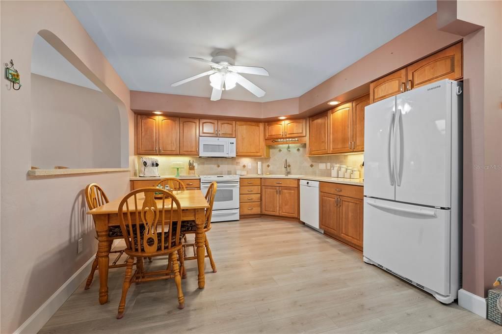 Spacious kitchen, wood cabinets, solid surface countertops