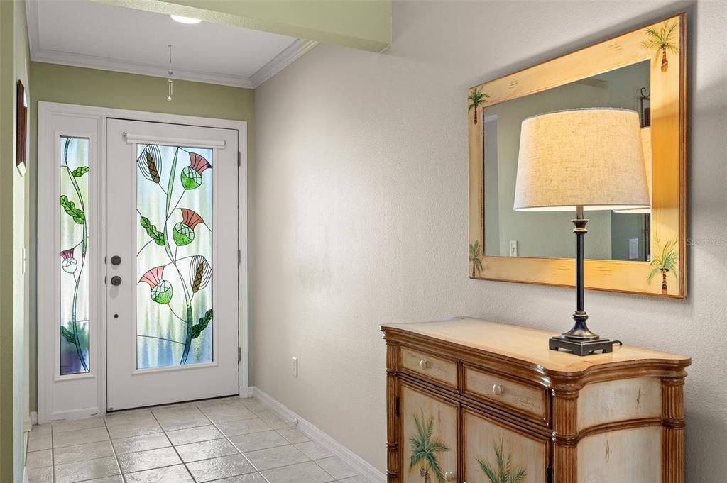 Foyer with tile and decorative front door.