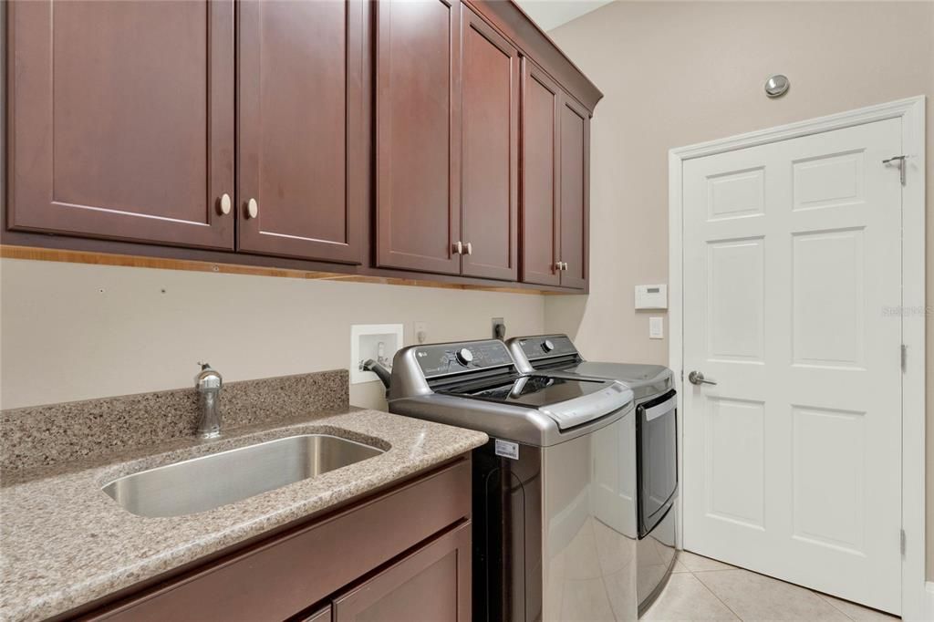 Inside laundry with ample cabinetry