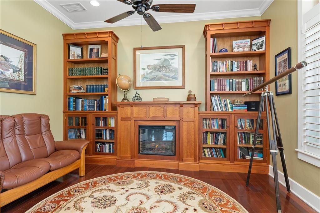 Off the foyer, find your private study/den with built-in shelving, fireplace, and French doors.