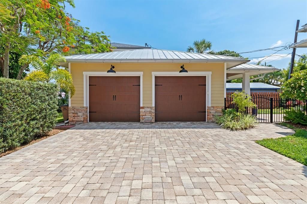 Oversized two-car garage with hurricane rated doors and ample driveway parking that easily accommodates you and your guests