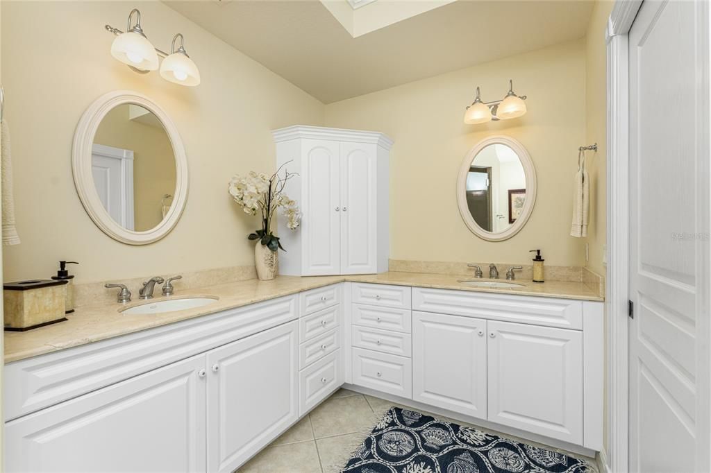 Crema Marfil marble counters enhance this en bath suite .