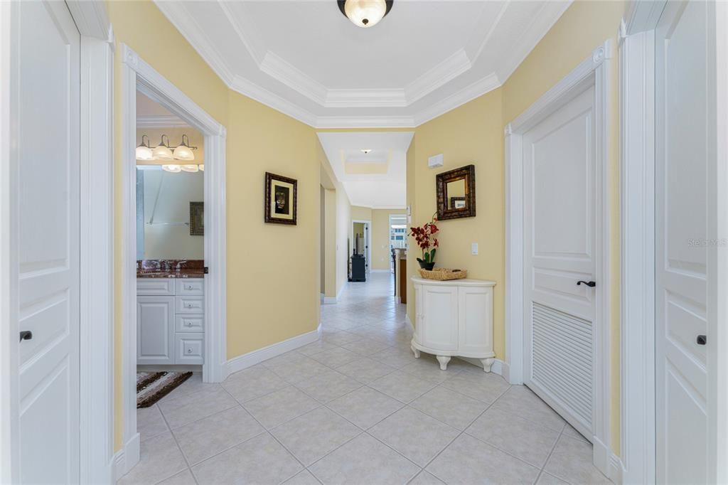 This exquisite entry could grace the pages of any upscale home magazine, finished with  tray ceiling, crown inlay moulding, designer door and baseboard millwork, solid core doors, generally reserved for a custom built home.