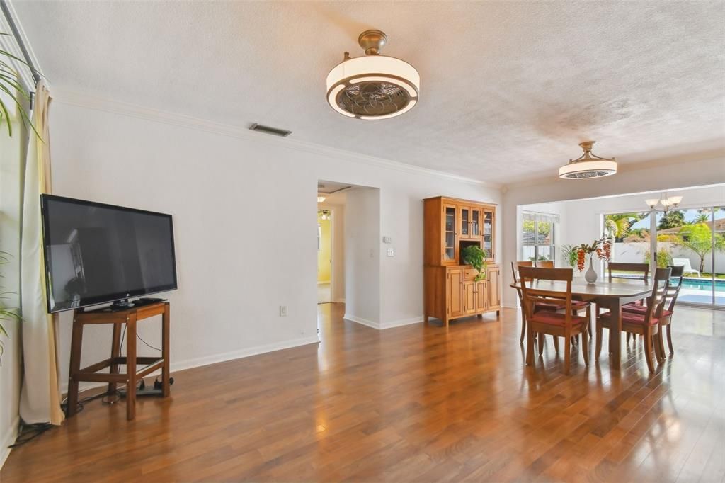 Living Room with enclosed ceiling fan, engineered hardwood floors. Home light and bright