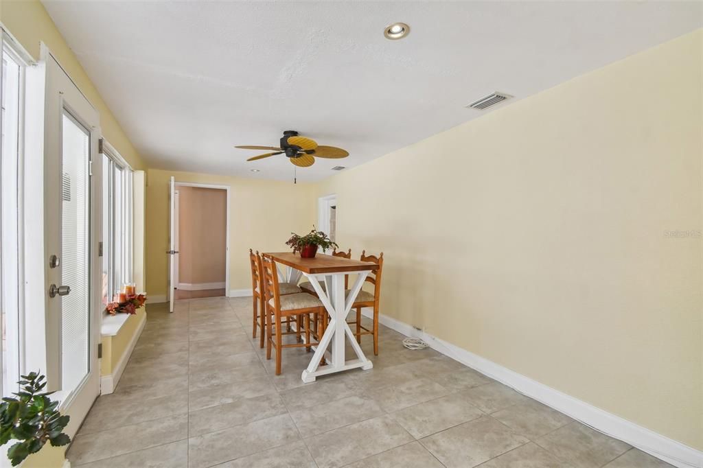 Florida Room with a lovely bank of windows, ceiling fans. Light and Bright