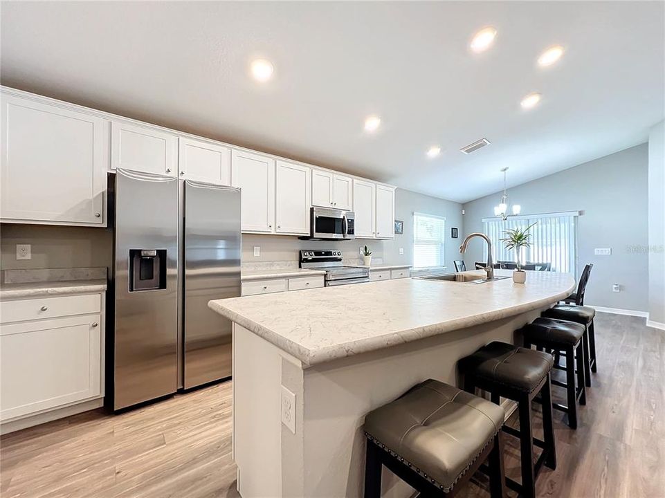 Kitchen features Quartz counter-tops and stainless steel appliances