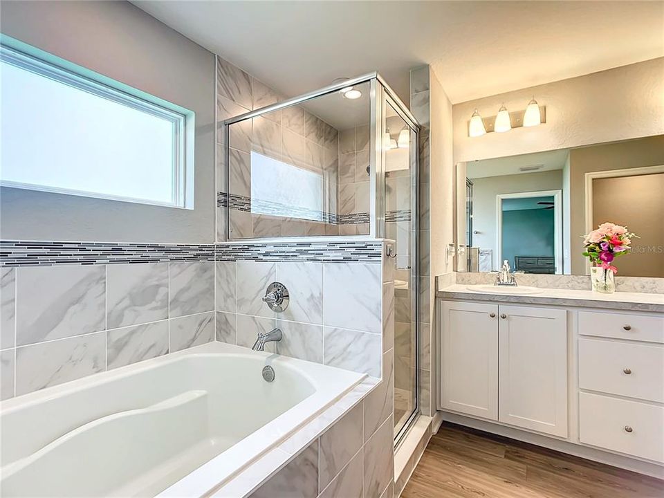 Separate soaking tub and Standup shower stall.