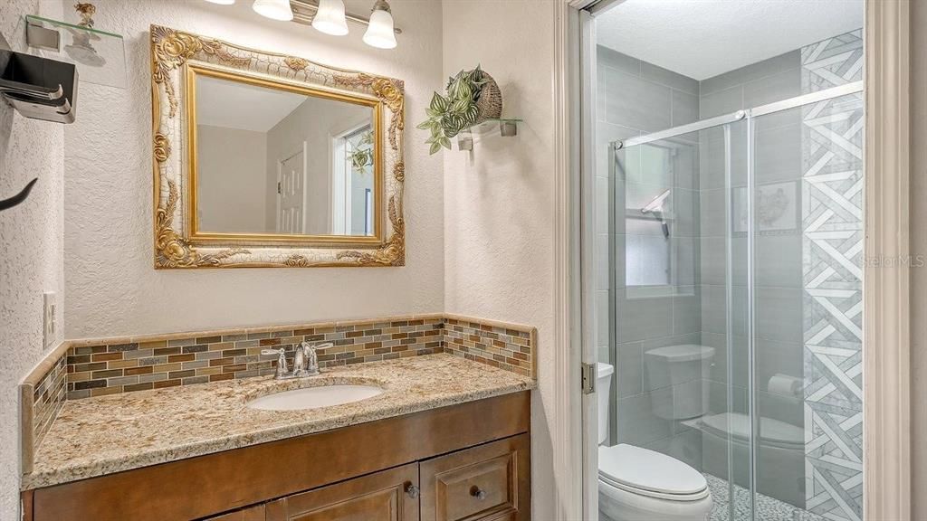 Owners ensuite bathroom featuring a glass enclosed walk-in shower.