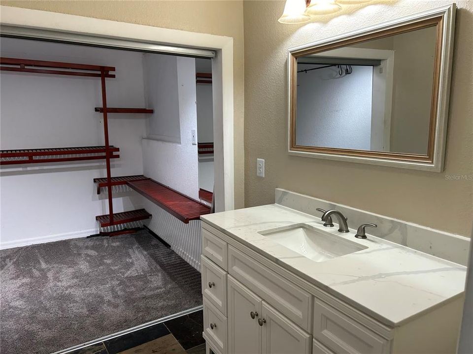 Primary bedroom walk-in closet