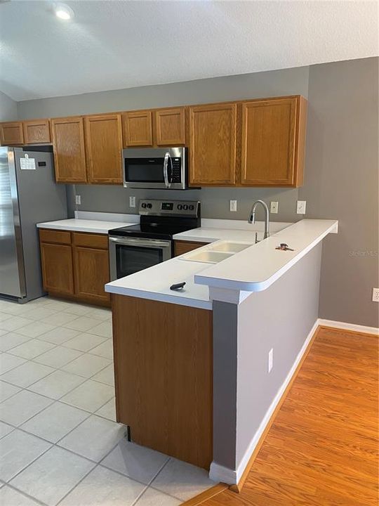 Large kitchen with new applicances and sit at bar