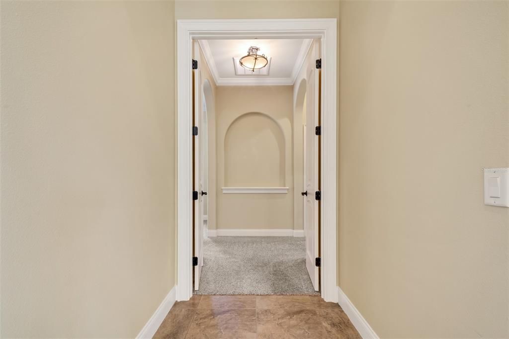 The owners Suite entrance, is very spacious..features his and her walk in closets, a wonderful well appointed bathroom and double french doors to the pool .