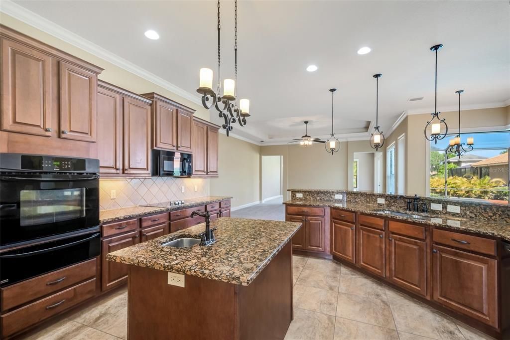 The kitchen features plenty of cabinet space, center island with prep sink, walk in pantry and inside laundry with washer & dryer.