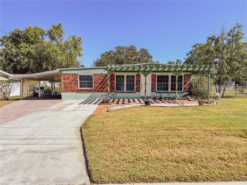 The gently pitched roof line of this meticulously maintained home aids in identifying it as a Mid Century Rambler.