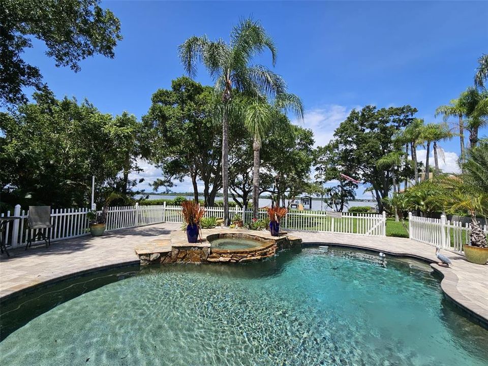 view of covered dock with boat & jetski lift