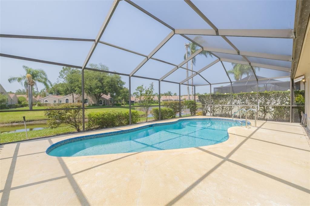 Enjoy the beautiful screened pool area with pond view
