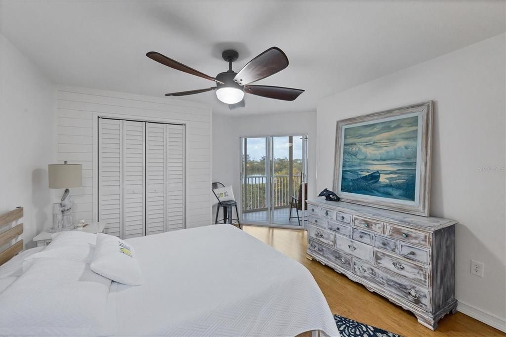 Primary bedroom with CREEK VIEW and additional closet.