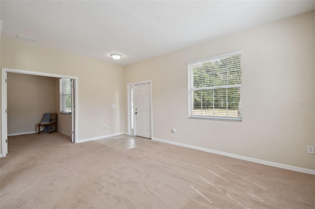 formal living room with double doors to the office