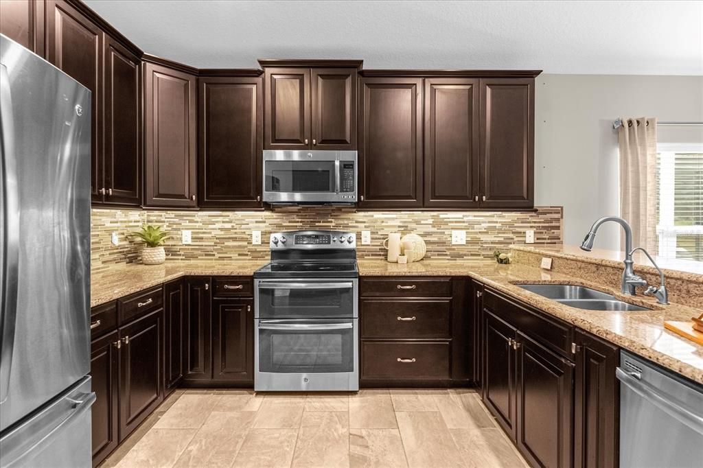 Kitchen with Stainless Steel appliances and under cabinet lighting.