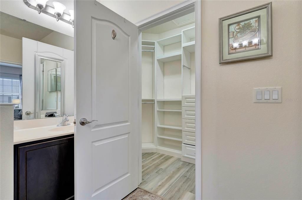 Primary walk-in closet with full built-in system