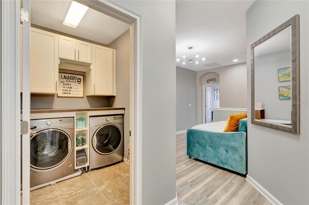 Spacious laundry room with built in cabinetry