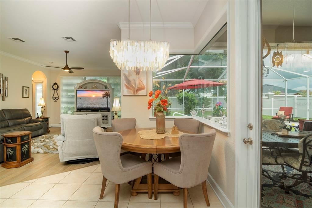 Breakfast nook with large glass panoramic window overlooking your private oasis of pool and lanai
