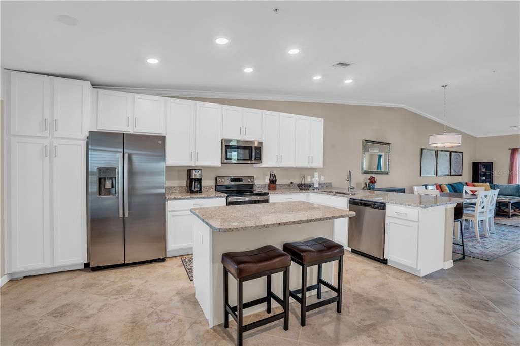 Kitchen features center island with seating & breakfast bar with additional seating.