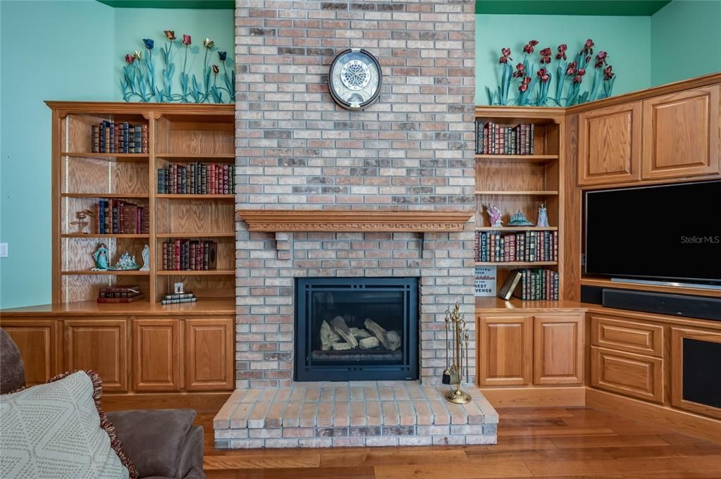 Brick Gas Fireplace & Built in Oak Cabinets