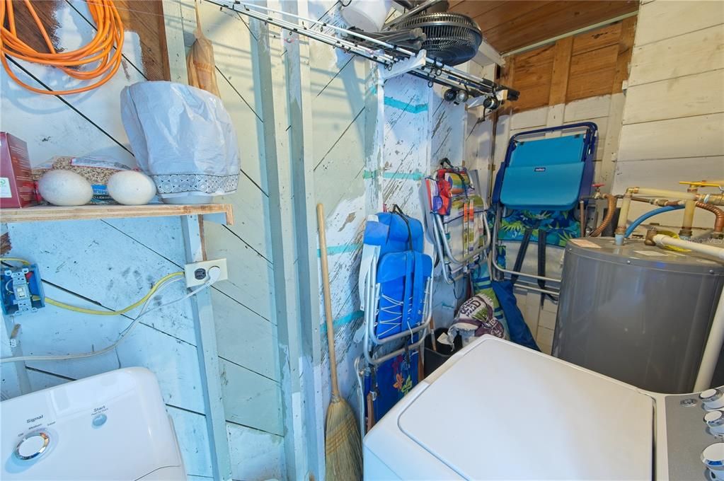Laundry room located off kitchen and has storage as well; accessed by door just of back door. Opportunity to remodel and convert to bath/laundry combo.