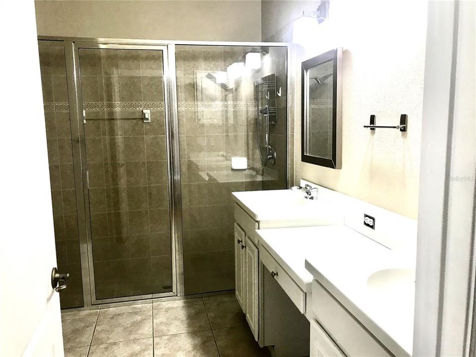 owner bathroom with separate shower and tub