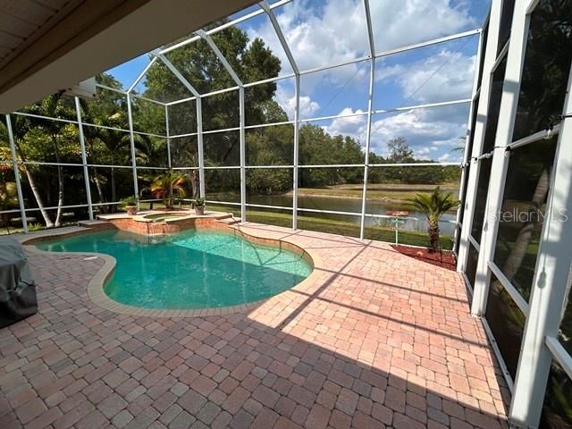 Screened pool with pond and conservation view.