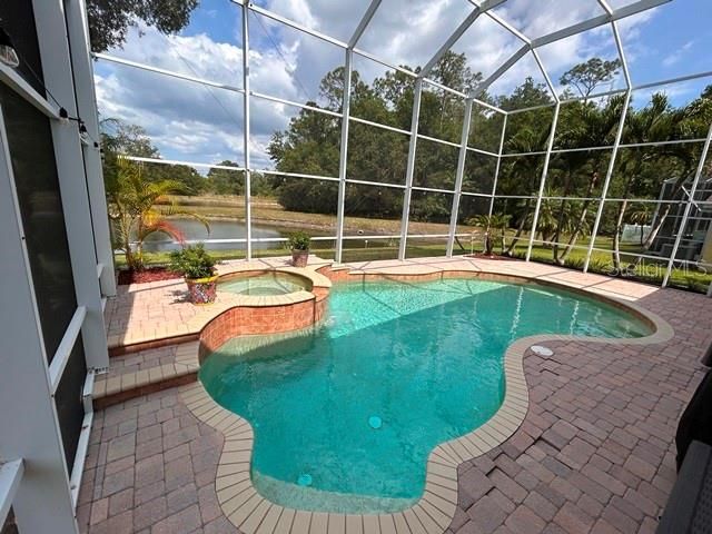 Screened pool looking to pond and conservation area.