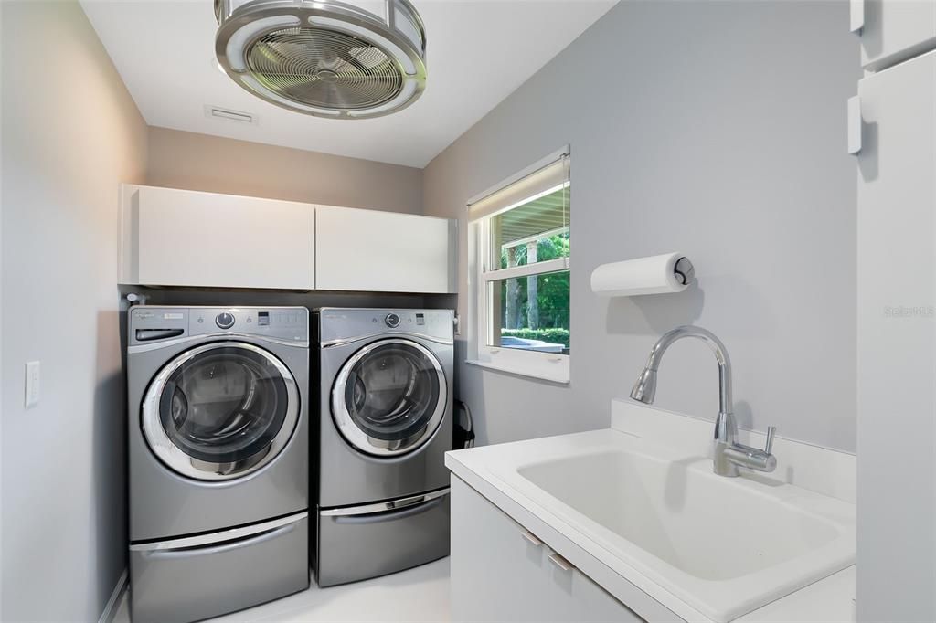 Laundry Room with Built-In Kraftmaid Cabinets and Utility Sink