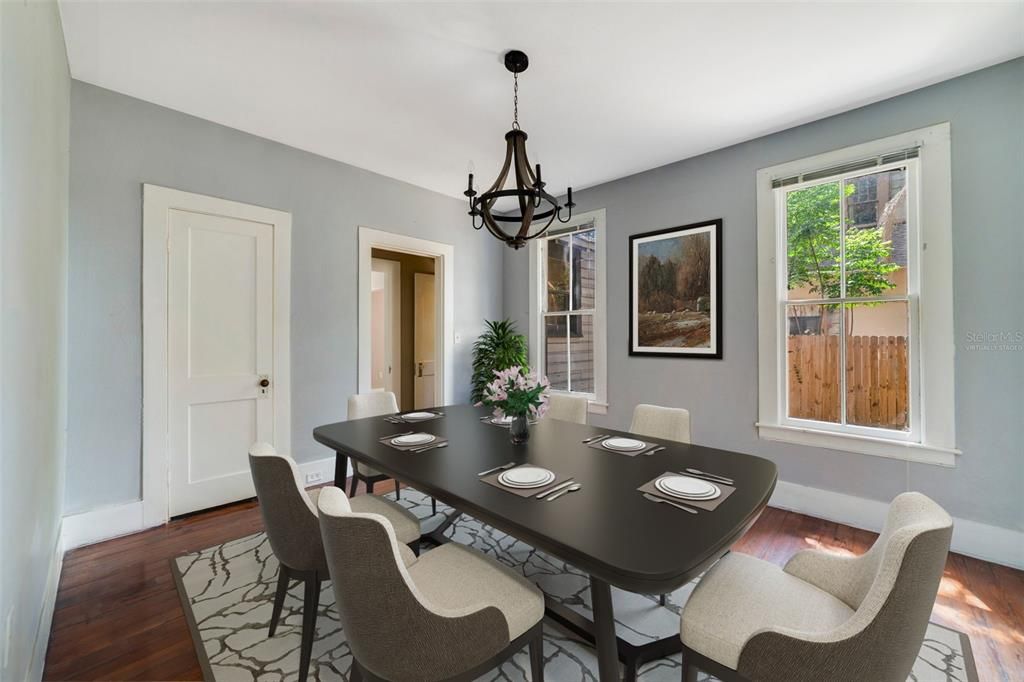 The formal dining room is a bright space that feels traditional while still being easily accessible to the transformed kitchen. Virtually Staged.