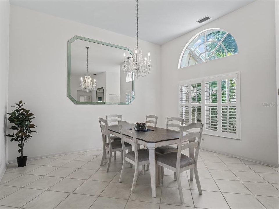 Dining room is Generous.  Plantation shutters and arched window add drama.