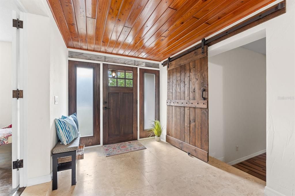 Stunning entry with tongue and groove ceiling with beautiful wood detail