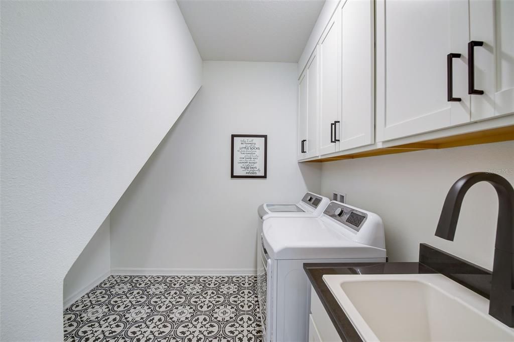 Laundry Room with sink, cabinets and under stairs storage