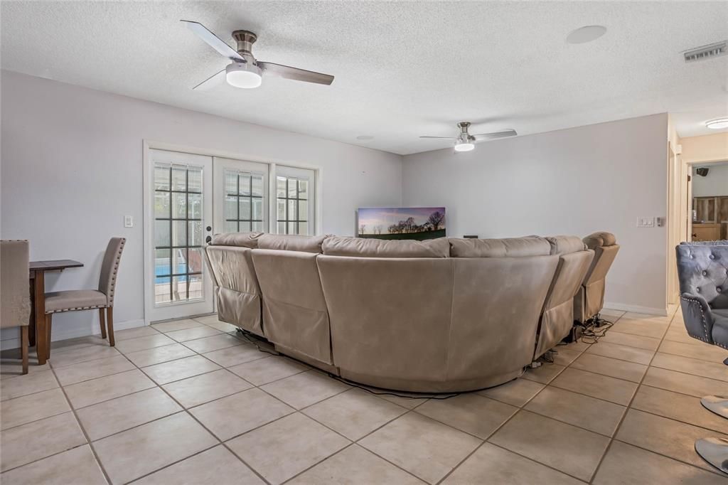The comfortable layout of this 3-bedroom, 2-bath home delivers TILE and LAMINATE WOOD FLOORS throughout, an UPDATED KITCHEN and BATHROOMS, large laundry room and French door access to a COVERED LANAI and the perfect place to relax poolside!