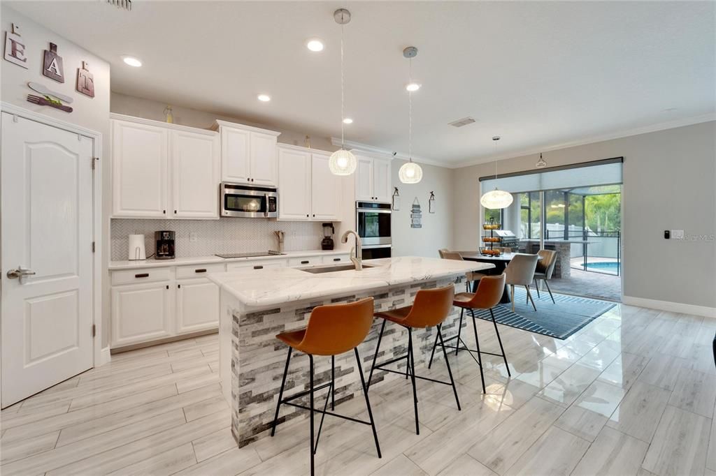 ALL NEW KITCHEN AND GRANITE COUNTERTOPS AND LARGE KITCHEN NOOK TO FIT A NICE SIZE TABLE AND OVERSIZED SLIDING GLASS DOORS TO YOUR PRIVATE OASIS, COMPLETE WITH HEATED POOL, WATERFALLFEATURE, NEW OUTDOOR KITCHEN WITH AWESOME GRILL, REFRIGERATOR, SINK AND STORAGE