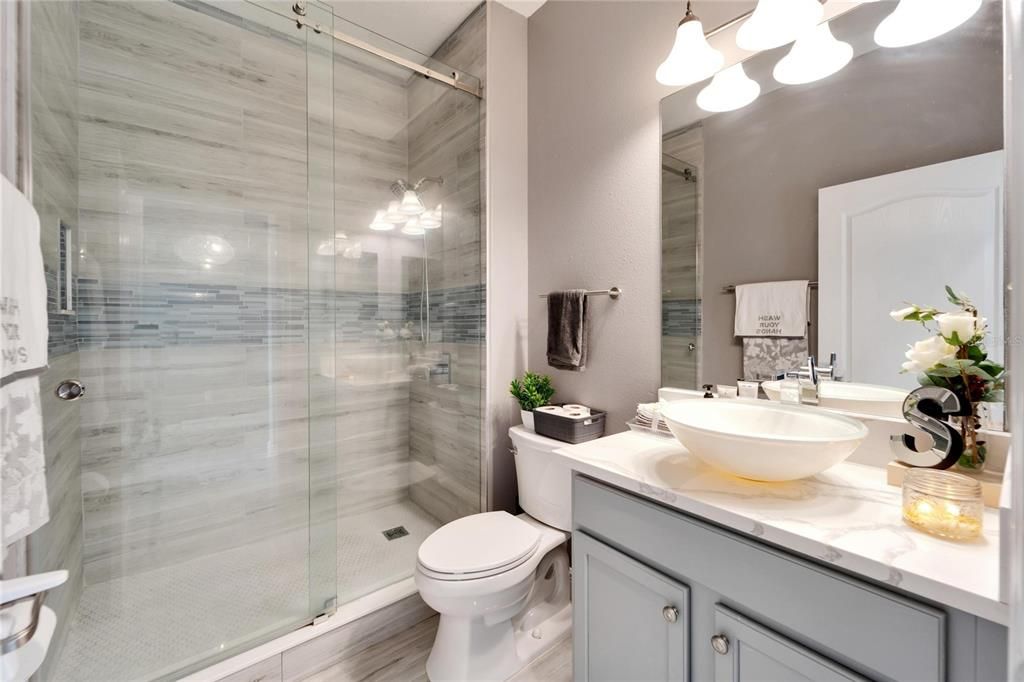GUEST BATH FIRST FLOOR COMPLETELY REMODELED AND GORGEOUS WALK IN SHOWER AND VANITY WITH GRANITE