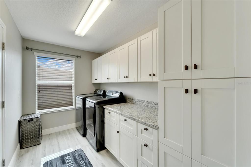 AWESOME LAUNDRY AREA THAT IS SPACIOUS AND BRIGHT AND EXTRA STORAGE IN NEW CABINETRY